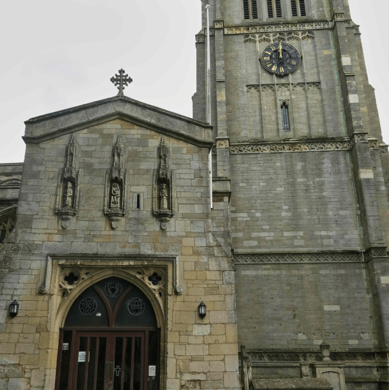 Three statues over the doorway to Kettering Parish Church.